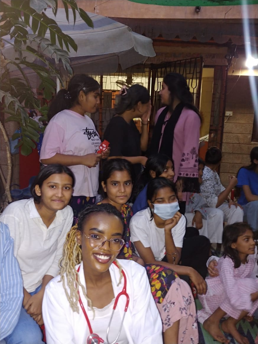 Children and a caregiver during a community wellbeing gathering